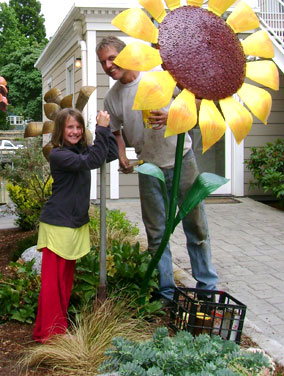 Kevin & his daughter, planting floweers. Really big ones.