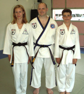 Michael Hoeller and Me’tairie Kilpatrick-Boe flank Senior Master Michael Rennick as they receive their belts....