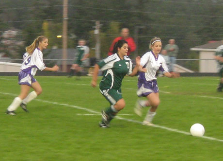 Midfielder Alex MacDonald (3 in white) runs down the ball for FHHS....