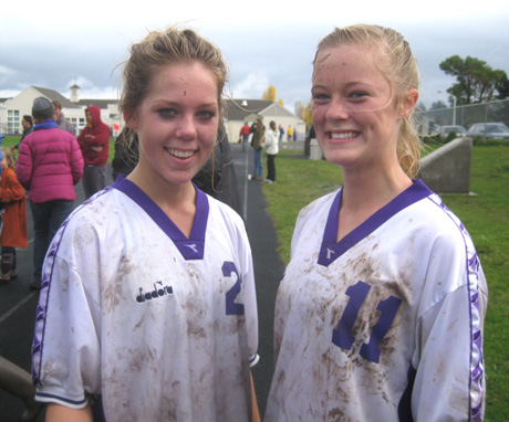 Emma (left) and Elle congratulate each other after the muddy game....