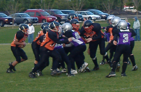 Quarterback Jerray Napier hands off to Willy Blackman while a strong offensive line holds back the Anacortes Seahawks.