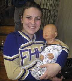 Kayla with the "baby" she looks after 24/7 for Child Psychology class...