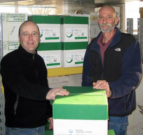County Pollution Prevention Specialist Brian Rader and Gerard Post van der Burg of Islands Paper & Supply Company with the first shipment of paper delivered under the new agreement.