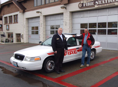 Chief Vern Long and former Mayor Bill LaPorte show off the "new" car