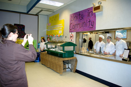 Liz takes a photo of her chefs before the crowd arrives.