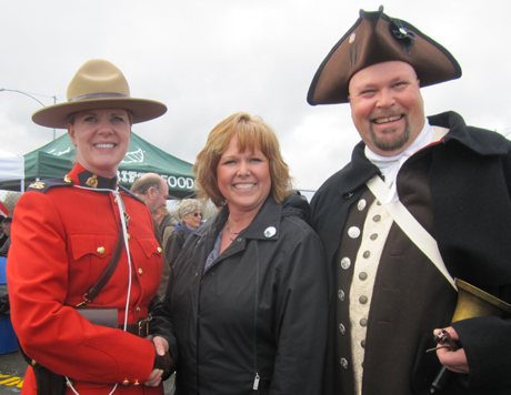 A Canadian mountie and American town crier greet San Juan Island Chamber of Commerce executive director Vernadel Peterson on Sunday to open the fiftieth year of the Anacortes-Friday Harbor-Sidney ferry run.