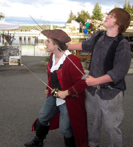 Pirates Cole (left) and Jacob look over the horizon for boats to board at the Port of Friday Harbor's Spring Fling...the event continues on Opening Day this Sunday.