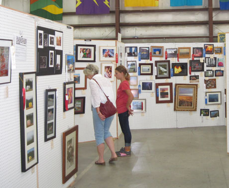 Fairgoers enjoy the photo exhibit at the 2012 fair -  Kevin Holmes photo