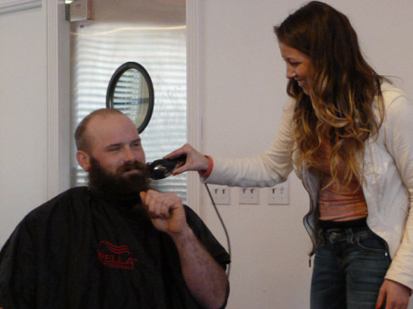 Chelsea Foussard shaving off Justin Miller's beard. They both built homes in this phase. Justin started growing his beard when he started building his house and vowed not to shave until it was complete.