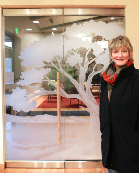 Artist Kathy Crain and new doors to the Peace Island Cancer Care Center. Photo by Marie DiCristina - click for larger view