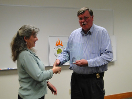 Kathy Cope accepts award from Fire Chief Steve Marler