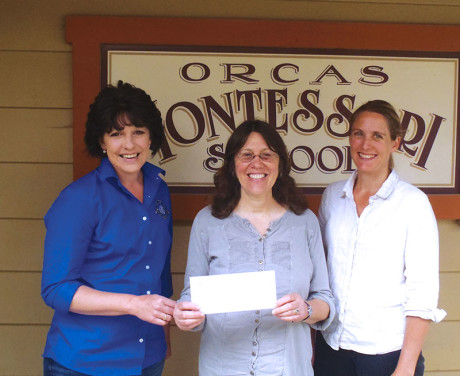 OPALCO Energy Services Specialist Elisa Howard presents a check for $10,000 to Teresa Chocano and Tina Whitman of the Orcas Montessori School