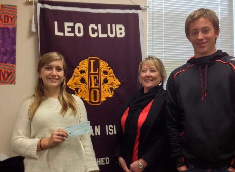 FHHS Leo Club officers, President Jacklyn Justiniano (left) and Treasurer Sam Stewart (right) present a check to SJPSF President Nancy Young.  The Leos designated the gift to support the school art program - Contributed photo - click for larger version
