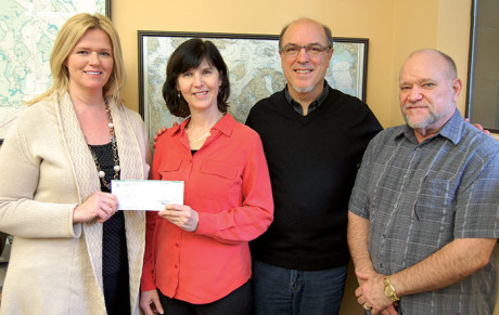 Amy Saxe of OPALCO’s Energy Services program presents a check to Linda Lyshall for the San Juan Islands Conservation District. Also pictured are Jay Kimball, consultant and Randy J. Cornelius, General Manager of OPALCO - Contributed photo