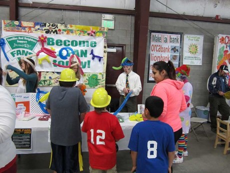 FANS members Cathy Kromer and Kyle Loring make balloons at last year's Children's Festival - Island Rec photo