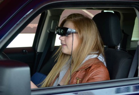 FHHS student Patricia Deitz attempts to drive the simulator and text at the same time - Tim Dustrude photo