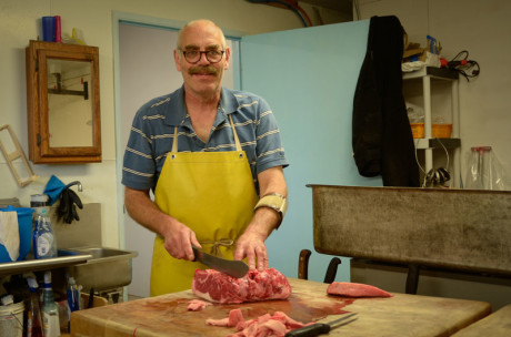 Ron Puetz cuts up some nice looking Rib Eye Steaks - Click to enlarge - Tim Dustrude photo