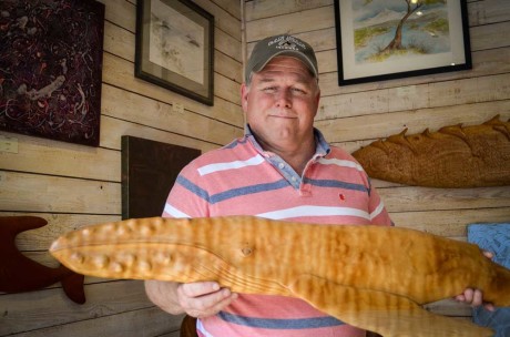 Artist Terry Ogle with his  work, "Tiger Striped Humpback", a carving of Quilted Western Maple local to the island - Tim Dustrude photo