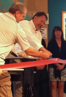 Mike Martin assists Duncan Wilson while Rebecca Parks (hidden) and Cynthia Burke stand by at the ribbon cutting launch of Whale Tale Cookies at the San Juan Island Whale Museum - Contributed photo