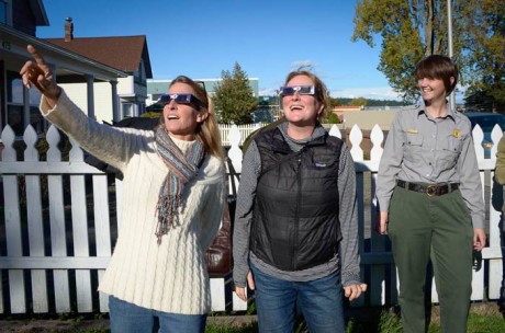 Gretchen Alison and Kari Koski enjoy the partial eclipse with the latest in fashionable eyewear while Raena Parsons looks on - Tim Dustrude photo