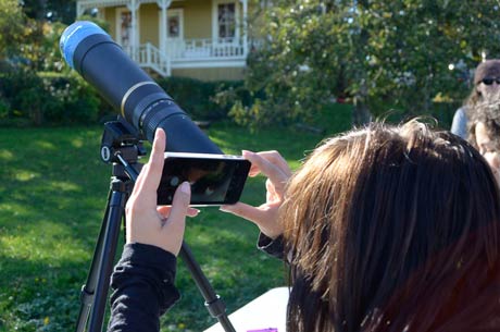 Emmie from the high school shoots a photo of the eclipse with her iPhone through the telescope - Tim Dustrude photos