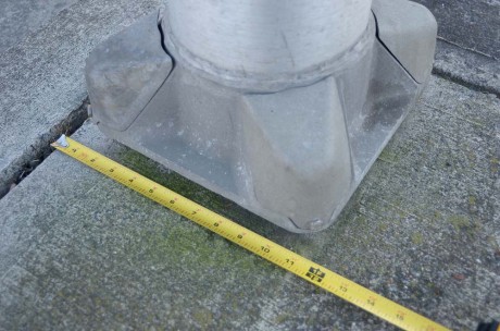 A close up shot of the light post on Nash St. This shows that it is only 12" into the sidewalk.