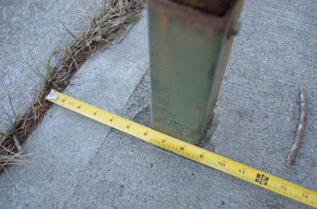 Sign post on Nash St. Only 9" into the sidewalk.