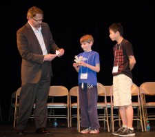 Rotary president Thomas Sandstrom presents awards to 1st place winner Justin Ha (at right) and 2nd place winner Joshua May - Tim Dustrude photo