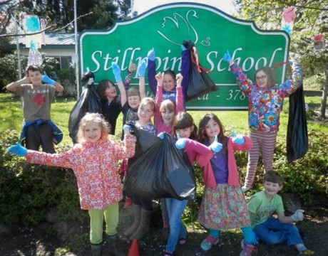 Stillpoint students show off the bags of trash they collected - Contributed photo