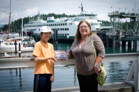 Levi Doenges delivers a puzzle to the very first customer, Nancy DeVaux who bought the puzzle off the website - Tim Dustrude photo
