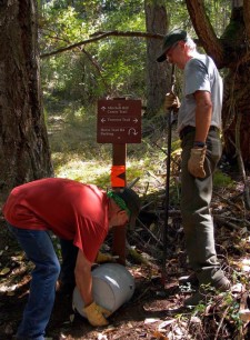Rik Karon from the Trails Committee and Todd Narum from the Park Service install one of the new signs on Mitchell Hill - Contributed photo