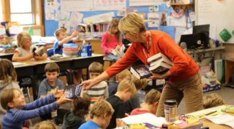 Rotary member, Cyndy Gilason hands out books to happy children - Ted Strutz photo