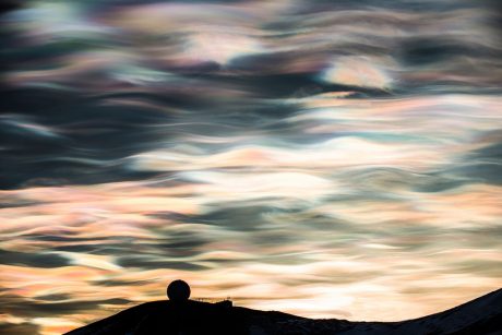 Rarely seen nacreous clouds over McMurdo Station are only visible when the atmosphere is exceptionally cold and the sun is just below the horizon. A once common sight, the increased temperatures and storms are making them a rare phenomenon even in Antarctica - Alasdair Turner photo