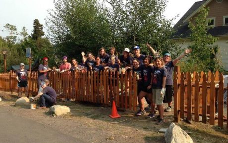 The "Bike and Build" team after they stained the fence at Sunrise Neighborhood - Contributed photo