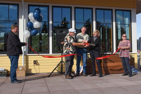 Port Commissioners Greg Hertel, Mike Ahrenius and Barbara Marrett cut the ribbon held by Current and former Port Directors Ted Fitzgerald and Marilyn O'Conner - Tim Dustrude photo
