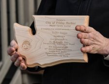 Greg Armstrong holds the plaque commemorating the completion of Phase One