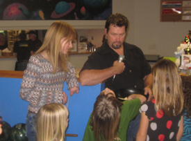 Heather & Ken get some help from the kids with Saturday night's raffle during the Xtreme Fitness anniversary party.